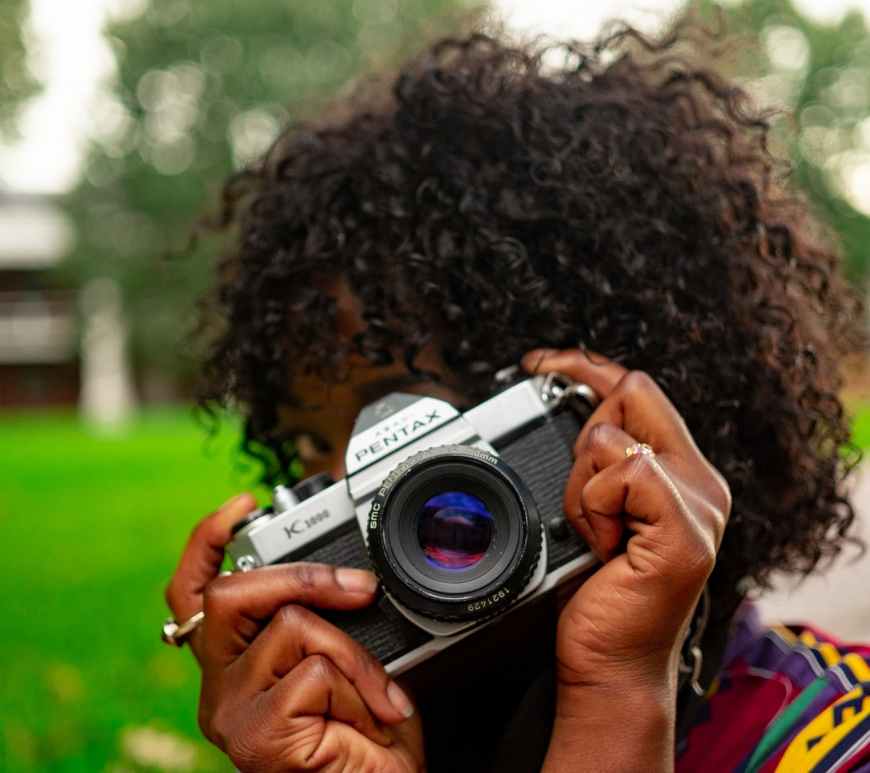 mujer tomando una foto con una cámara